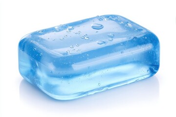 A clear blue soap bar sits on a white surface, glistening with small water droplets. Its smooth texture and vibrant color suggest freshness and cleanliness, ideal for personal care.