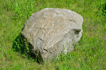 Stone, boulder, in a meadow,