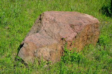 Stone, boulder, in a meadow,