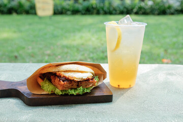 sandwich with lemonade on the table in the garden, stock photo