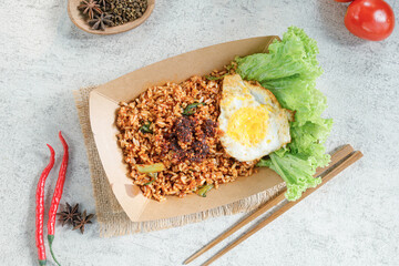 Thai style fried rice with fried egg in a paper box