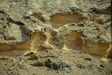 Close-up of layered sedimentary rocks shaped by erosion in Sharjah’s ancient desert mountains, UAE. A geological snapshot from millions of years ago.