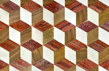 Close up of random cut marble floor tiles pattern in 3D cube and hexagonal pattern. 3D Geometrical floor pattern in red, beige, and white color. Seamless background texture