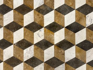 Close up of random cut marble floor tiles pattern in 3D cube and hexagonal pattern. 3D Geometrical floor pattern in brown, black, and white color. Seamless background texture