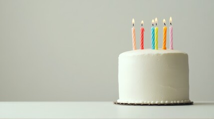 A simple yet sophisticated birthday cake with candles, standing against a clean white background,
