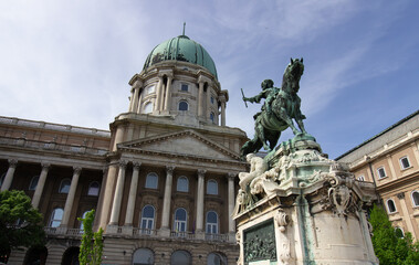 Equestrian statue and dome of Buda Castle with classical columns in Budapest, Hungary