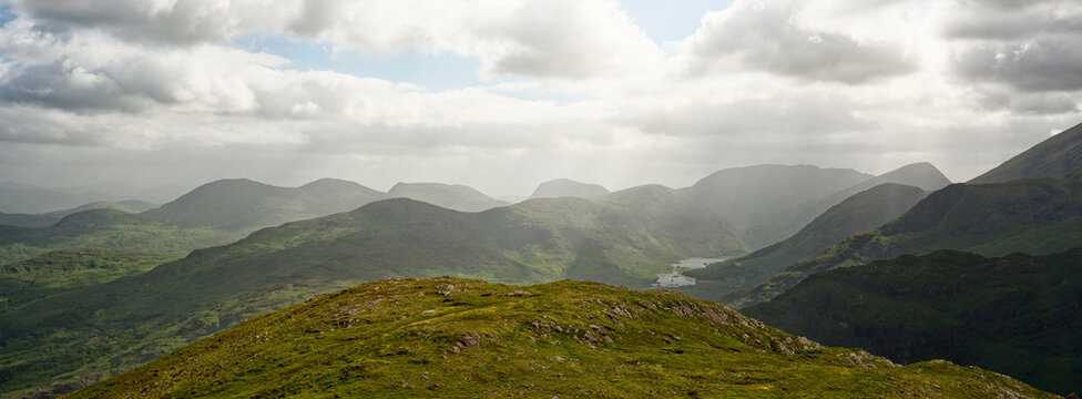 Breathtaking landscape of Blackvalley, Ireland showcasing rolling hills and distant mountains under cloudy sky.