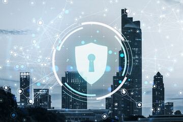 Cybersecurity shield icon over modern city buildings with digital network overlay on light blue background, symbolizing data protection concept.