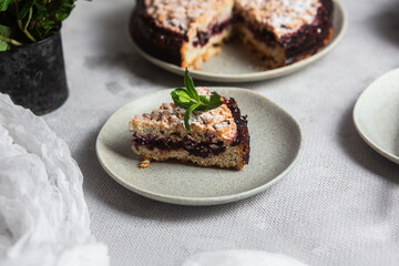 Round Pie with black currants and mint in a plate on the table. Dessert