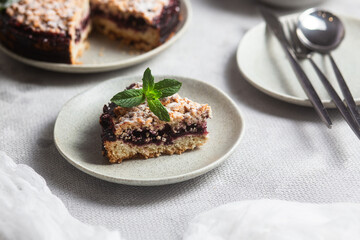 Round Pie with black currants and mint in a plate on the table. Dessert