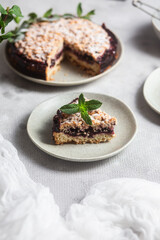 Round Pie with black currants and mint in a plate on the table. Dessert