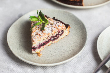Round Pie with black currants and mint in a plate on the table. Dessert