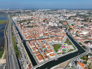 Fototapeta premium Drone image of Aveiro, Portugal featuring canals, colorful buildings and compact urban design