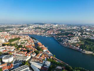 Obraz premium High aerial shot of Porto, Portugal featuring the iconic Douro River surrounded by historic buildings