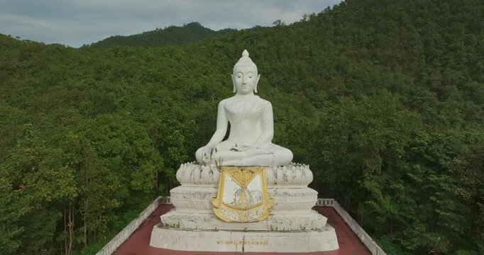 Aerial view Wat Phra That Mae Yen, an ancient temple that has been a symbol of Pai for a long time. Phra Phuttha Lokuttara Mahamuni, a large white Buddha statue in the Mara-Vijaya attitude on hilltop
