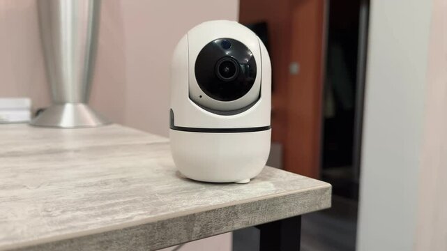 A home security camera demonstrates its 360-degree rotation and vertical tilt capabilities during testing indoors.