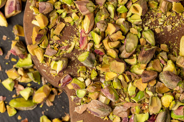 pistachios for cooking , chopped into pieces crispy pistachios fried with salt, close up, top view