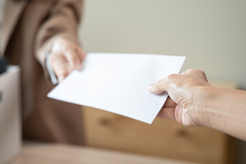 Obraz premium Unemployment ,jobless crisis, worker layoff concept, Close-up of young businessman pack stuff off the desk and holding boxes of self stuff when quitting the job after send resign letter from company