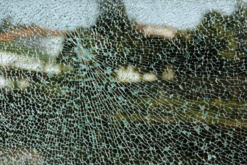 Broken glass with trees in the background