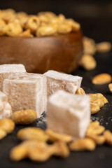 sugar cubes with starch and toasted peanuts on a black slate surface