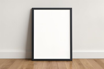 Framed Poster Mockup Leaning Against Wall on Wooden Floor