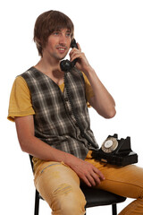 Vintage storytelling unfolds as a young man connects via classic rotary phone