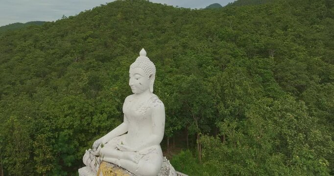 Aerial view Wat Phra That Mae Yen, an ancient temple that has been a symbol of Pai for a long time. Phra Phuttha Lokuttara Mahamuni, a large white Buddha statue in the Mara-Vijaya attitude on hilltop