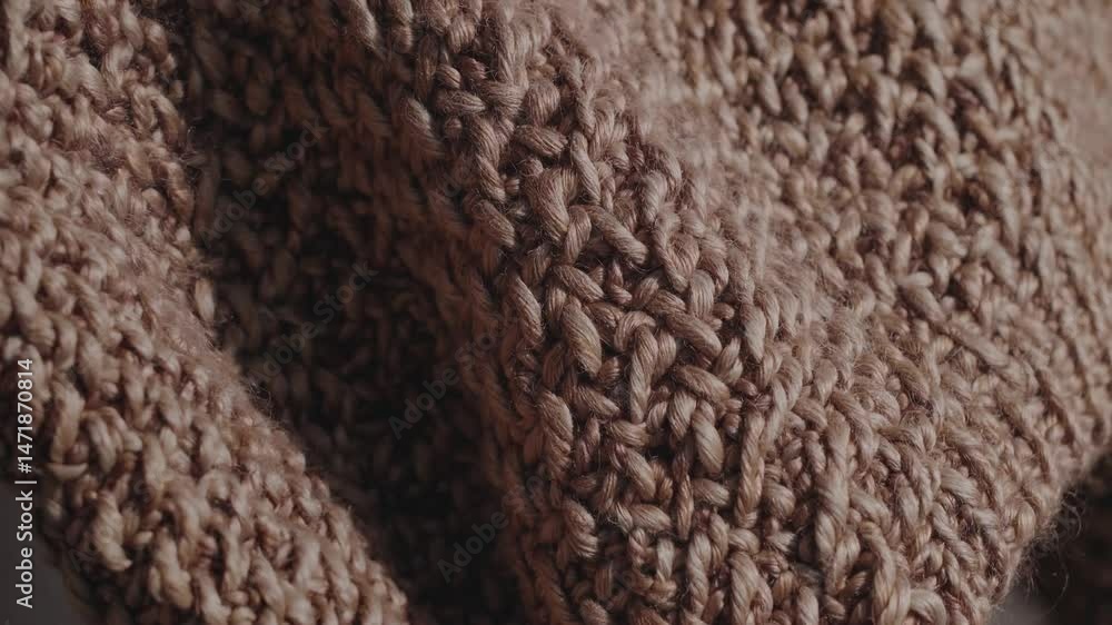 Aufkleber woolen textile dynamically transforming, revealing intricate knit textures and soft material pattern