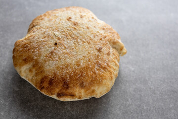 flatbread on gray surface (side view)