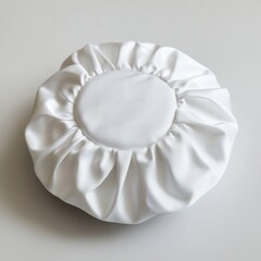 Round, white, pleated decorative cushion