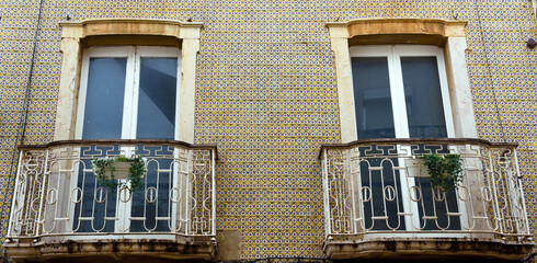 characteristic windows of historic buildings in faro algarve portugal