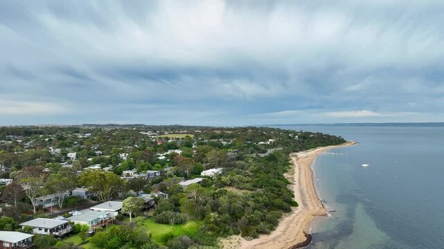 Aerial drone shot of the sea, beach and land near Big4 in Phillip Island Australia