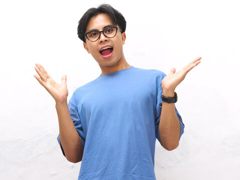 Portrait of shocked and Amazed Asian man looking at the camera. shocked face Asian man looking at empty space at left. Amazed and feels shocked asian man. Indonesian man with surprised expression.