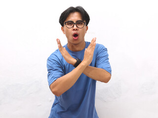 Asian young man with serious face posing making stop sign with hand, Angry Asian young man doing...