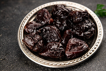 Prunes dried fruit smoked plum snack fresh delicious gourmet food background on the table rustic...