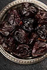 Prunes dried fruit smoked plum snack fresh delicious gourmet food background on the table rustic food top view copy space keto and paleo diet vegetarian and vegan food