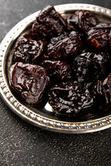 Prunes dried fruit smoked plum snack fresh delicious gourmet food background on the table rustic food top view copy space keto and paleo diet vegetarian and vegan food