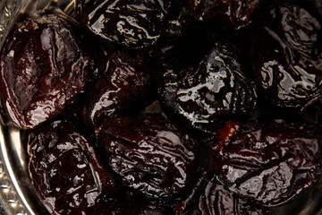 Prunes dried fruit smoked plum snack fresh delicious gourmet food background on the table rustic food top view copy space keto and paleo diet vegetarian and vegan food