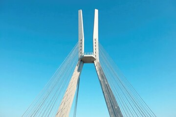 Fototapeta premium Modern bridge tower against a clear blue sky Sleek design, metallic structure, architectural detail , aesthetic, perspective