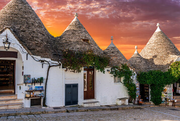 Touristic italian town near Bari of Alberobello with ancient beautiful buildings trulli with white...