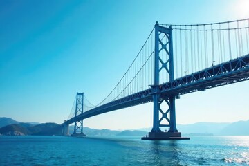 Fototapeta premium Sky blue suspension bridge against a clear sky Perfect for travel, infrastructure, and engineering projects , aerial, sky, scenic