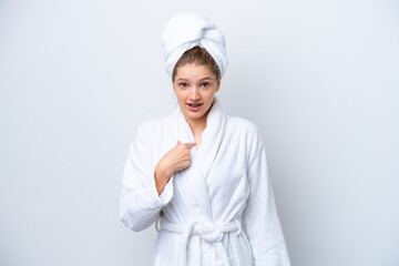 Teenager Russian girl in a bathrobe isolated on white background with surprise facial expression