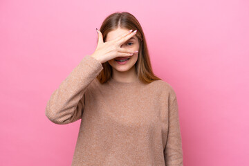 Teenager Russian girl isolated on pink background covering eyes by hands and smiling