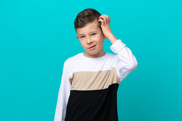 Little kid boy isolated on blue background with an expression of frustration and not understanding