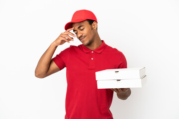 African American pizza delivery man picking up pizza boxes over isolated white wall laughing