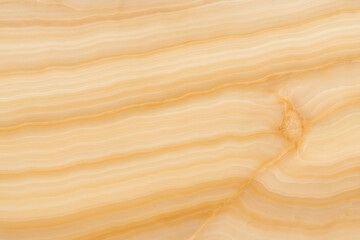 Close-up of a polished onyx stone surface showing natural veins.