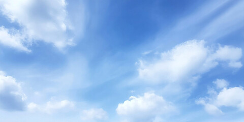 Fototapeta premium Expansive blue sky with dynamic white clouds creating serene and peaceful atmosphere, perfect for relaxation and contemplation