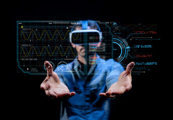 Person Using Virtual Reality Headset with Interactive Digital Display in a Dark Room for Immersive Technology Experience