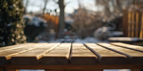 Fototapeta premium Wooden Table Covered in Frost on a Winter Day in a Garden Setting with Sunlight and Snow Accents
