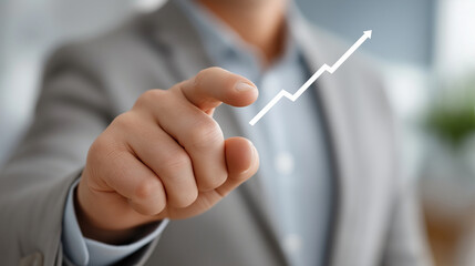 Driven success, a focused hand confidently points towards a rising graph, symbolizing ambition, Professional Man Points Toward Growing Financial Success